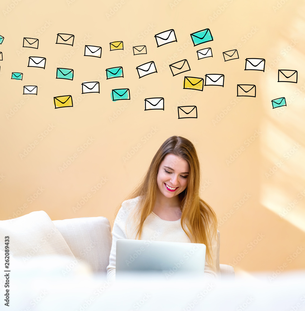 Many emails with young woman using her laptop computer at home