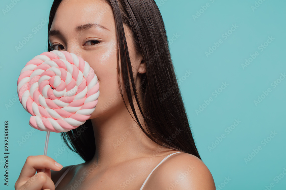 Young woman with a sugar candy