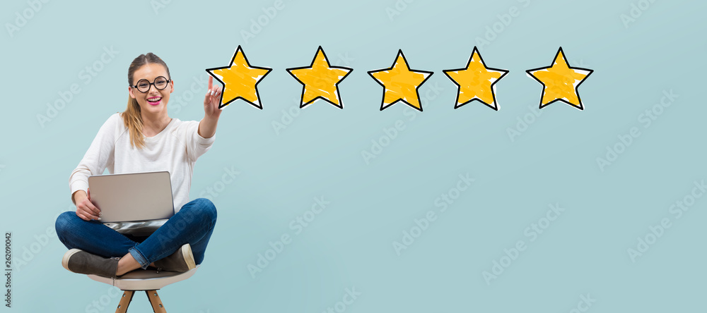 Five star rating with young woman using her laptop