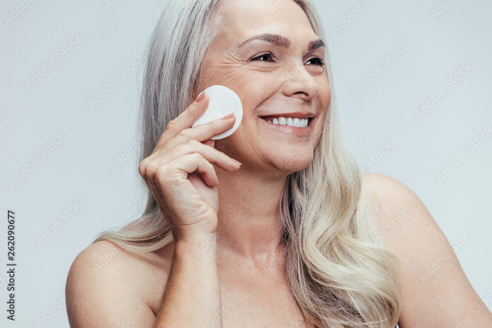 Woman cleansing her face