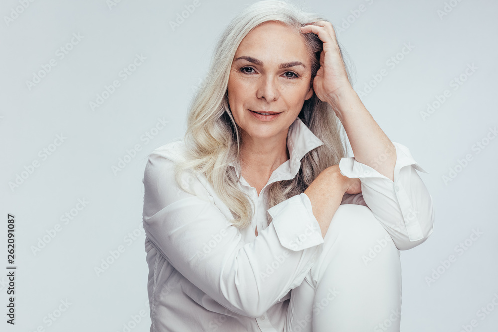 Pretty senior woman in white casuals