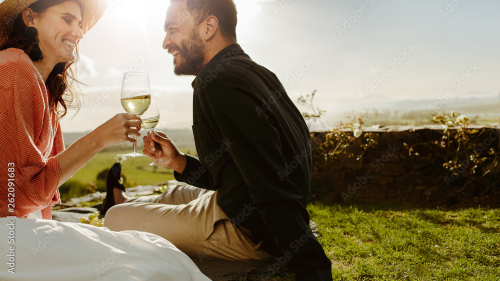 Couple on a date near a wine farm drinking wine