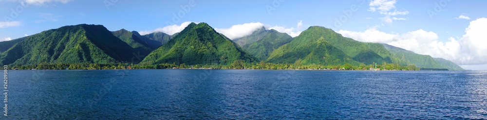 DRONE Flying over the deep blue sea and towards the towering mountains of Tahiti