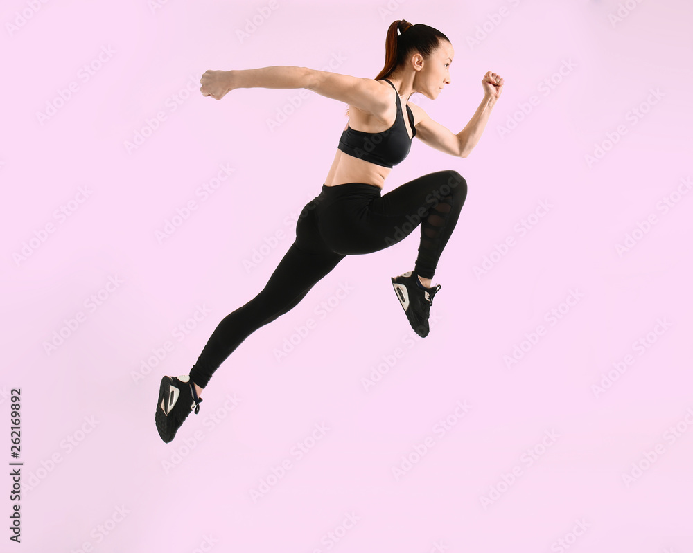 Sporty running woman on color background