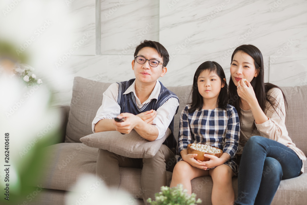 Happy Asian family lifestyle enjoy watching TV at home