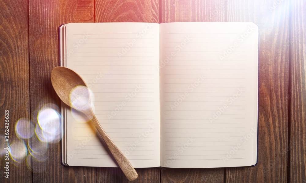 Empty notebook for recipes with spoon