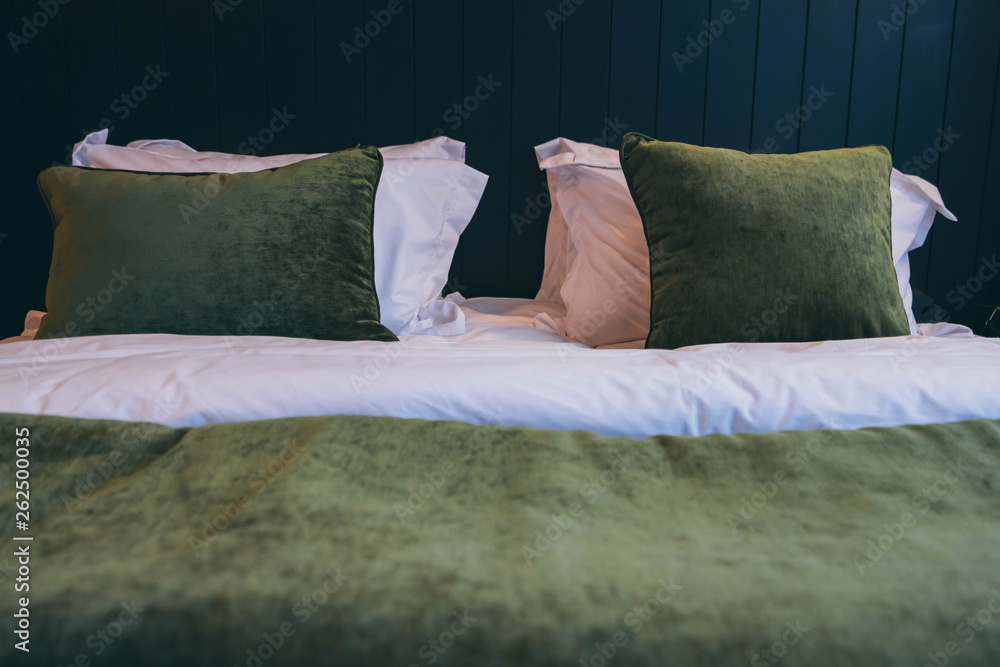 Bed maid-up with clean white pillows and bed sheets in beauty bedroom. Close-up. interior background