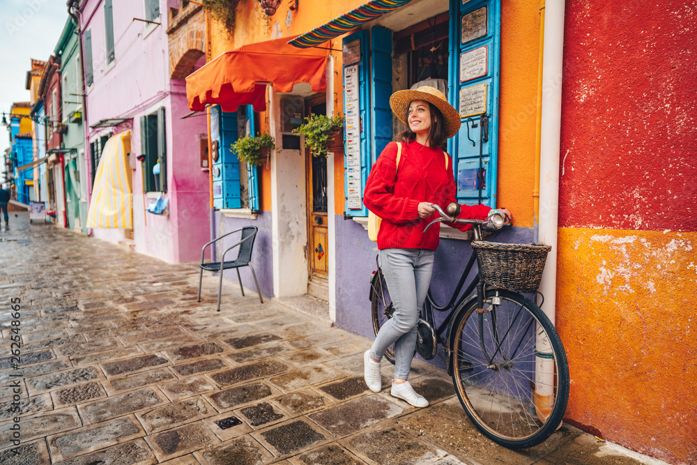 Smiling girl with a bike in Italy