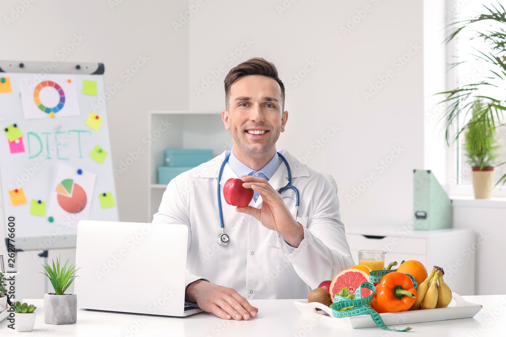 Portrait of male nutritionist in his office