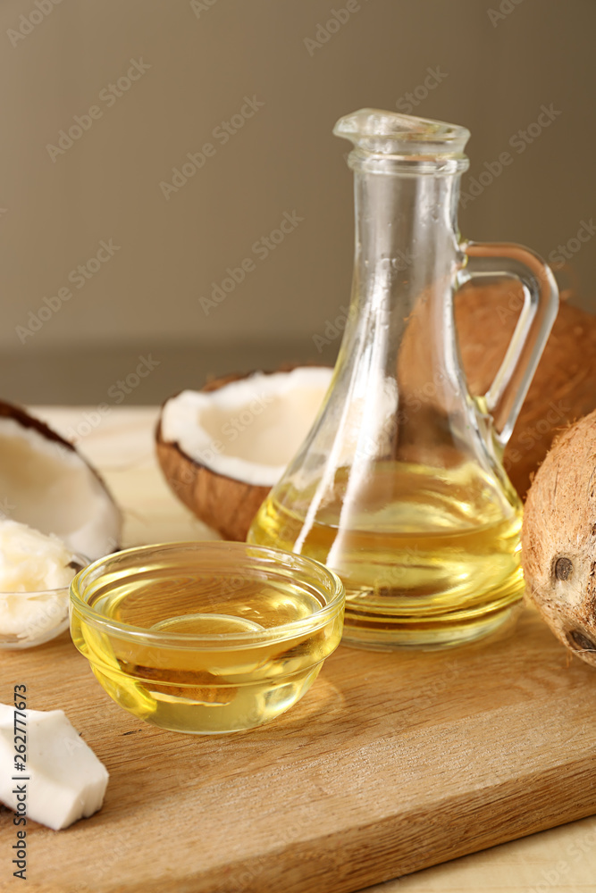 Jug and bowl with coconut oil on table