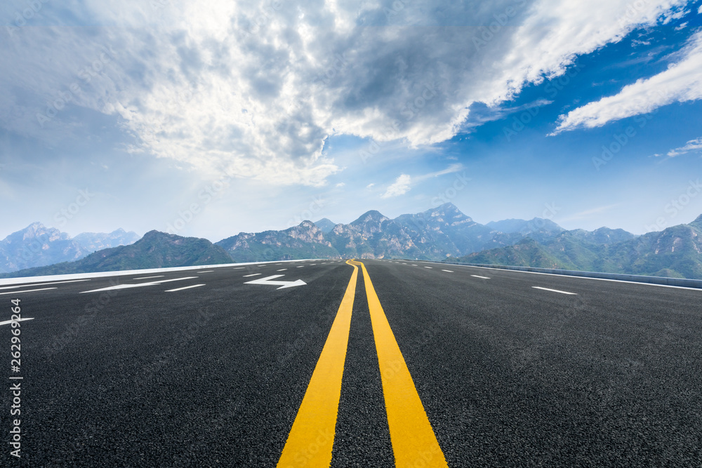 Empty asphalt road and mountains with beautiful clouds landscape