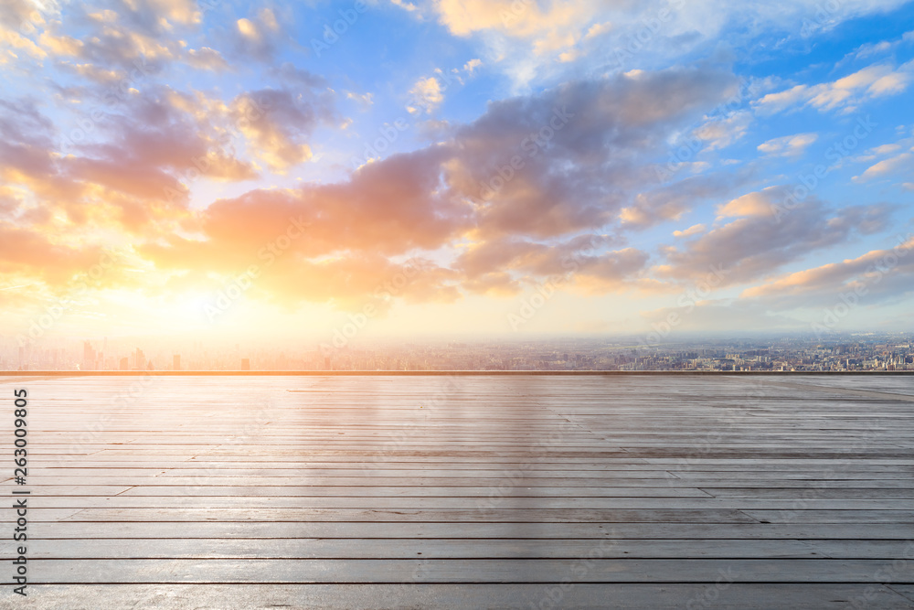 Shanghai city skyline and wooden platform with beautiful clouds at sunset,high angle view