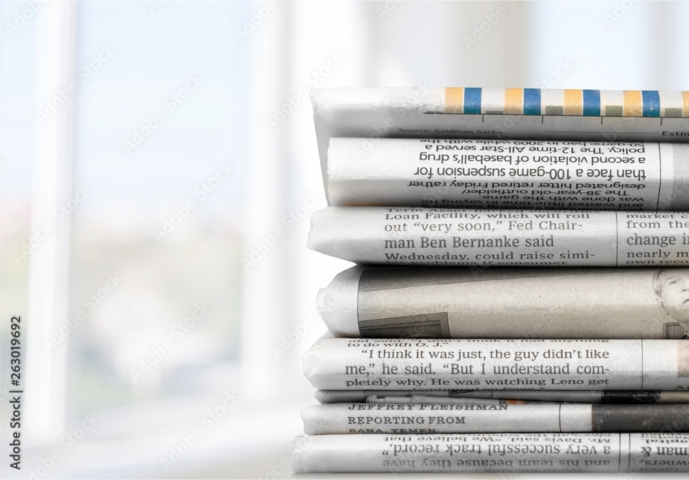 Pile of newspapers on white background