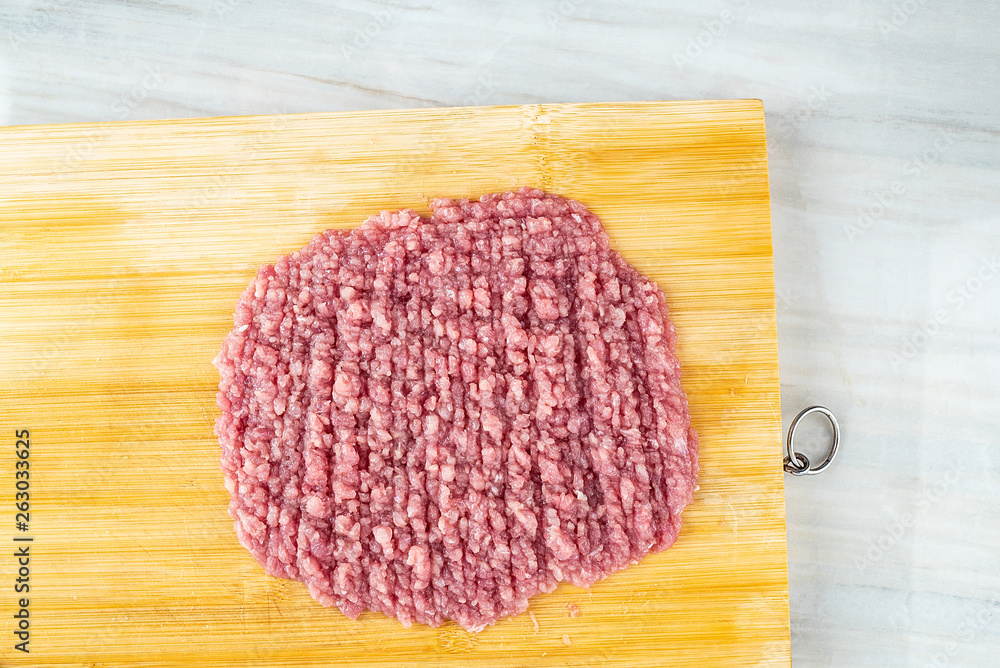 Minced pork puree on bamboo cutting board