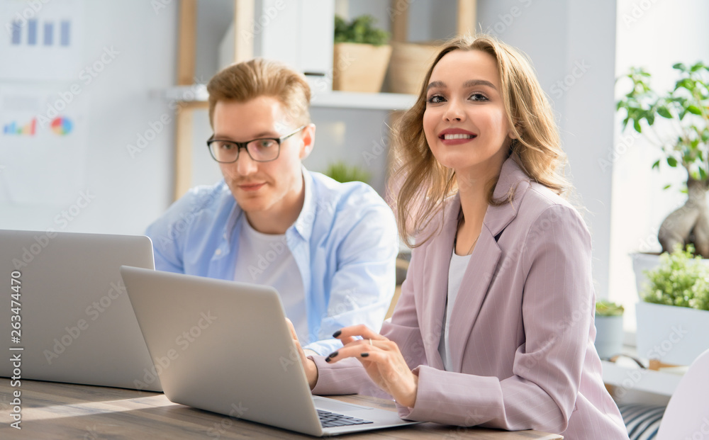 man and woman working in the office