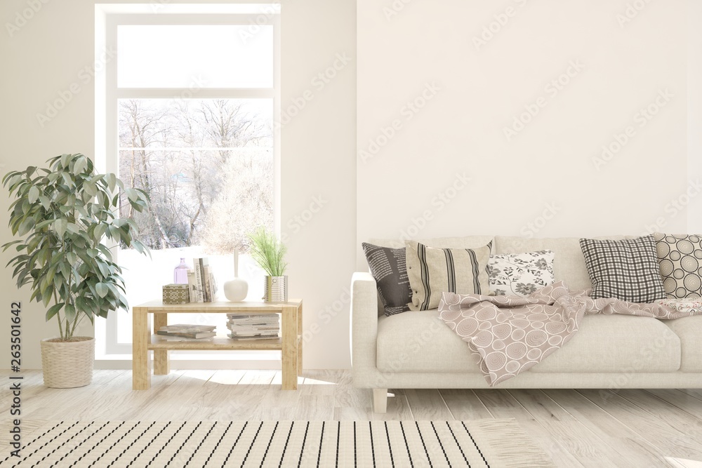 Stylish room in white color with sofa and winter landscape in window. Scandinavian interior design. 