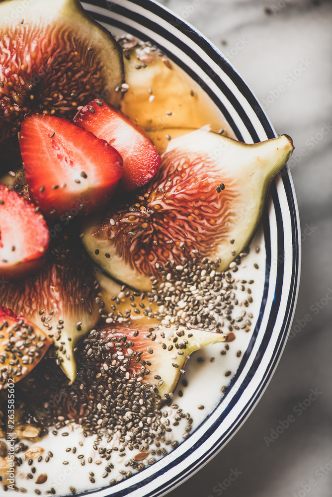 Healthy breakfast. Flat-lay of Greek yogurt granola bowl with strawberry, figs, peach, chia seeds an