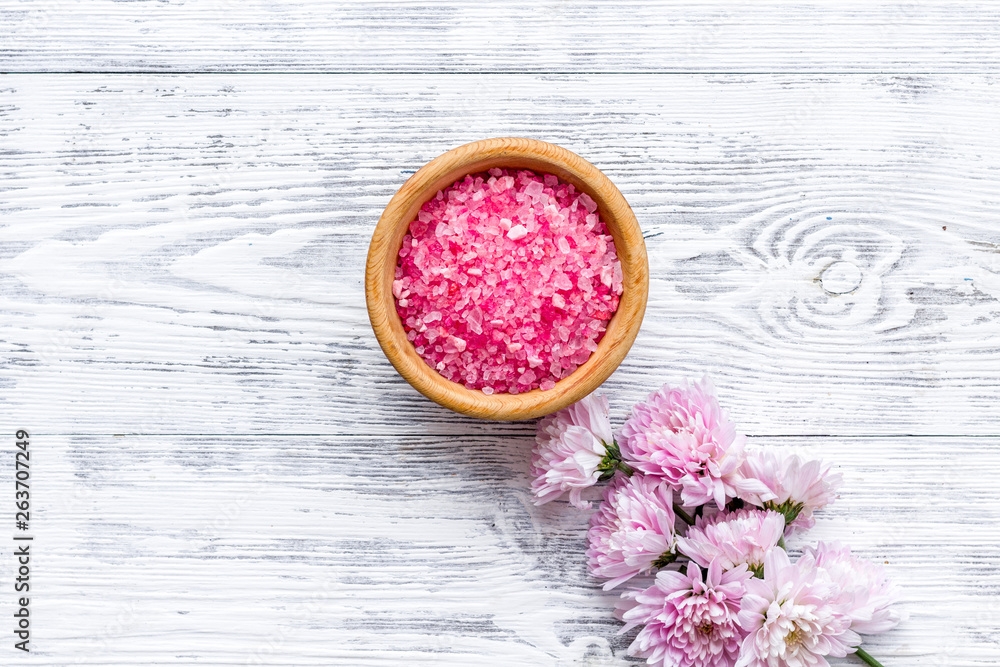 aroma therapy with pink flower fragrance and spa salt on white wooden background top view space for 