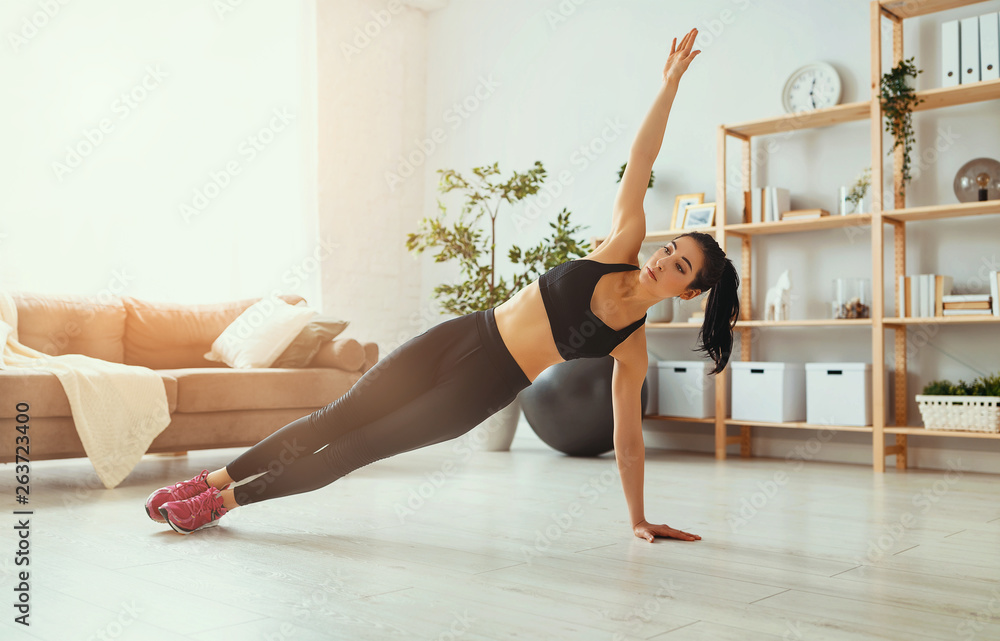 young woman doing fitness and sports at home    .