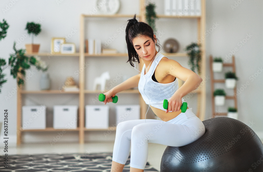 young woman doing fitness and sports at home