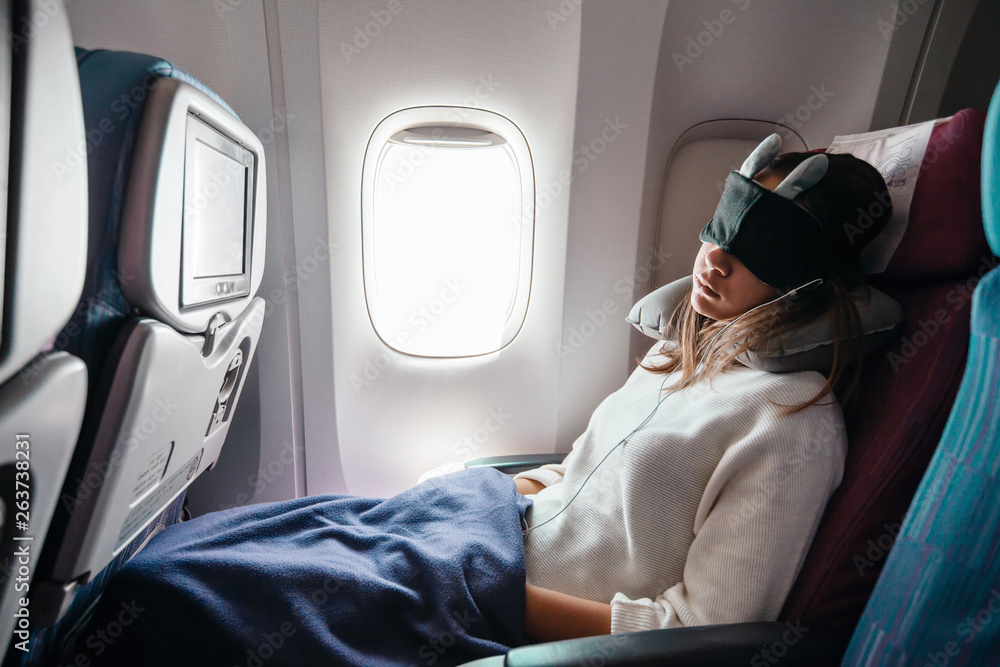 Teenage girl travelling by airplane