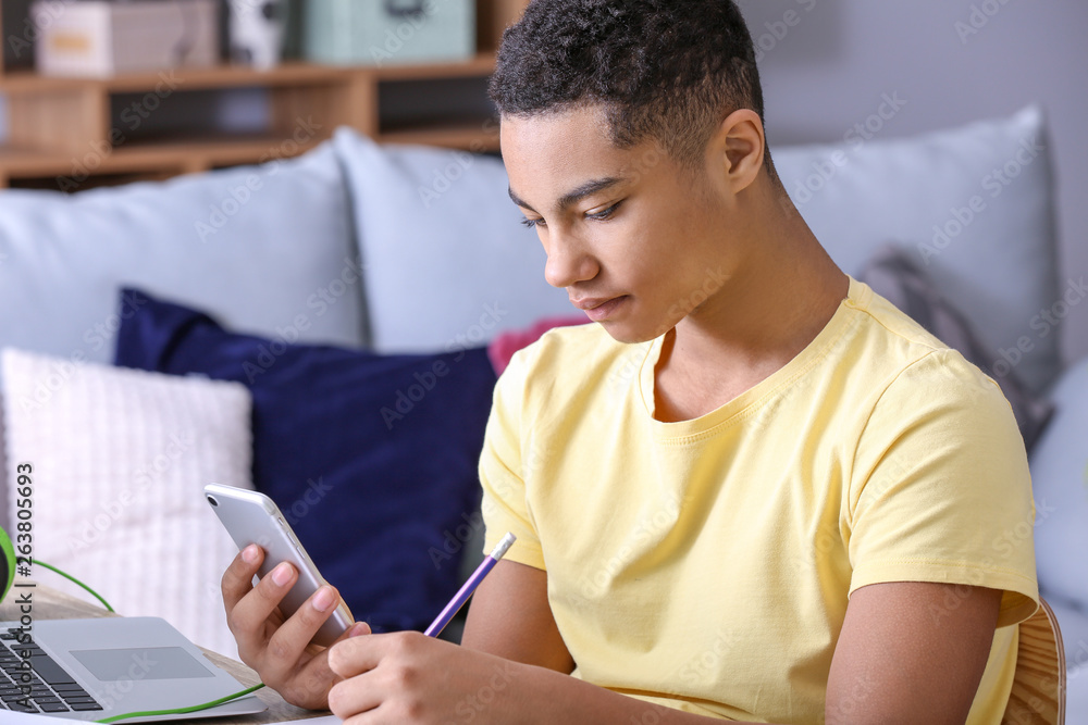 African-American teenage boy doing homework