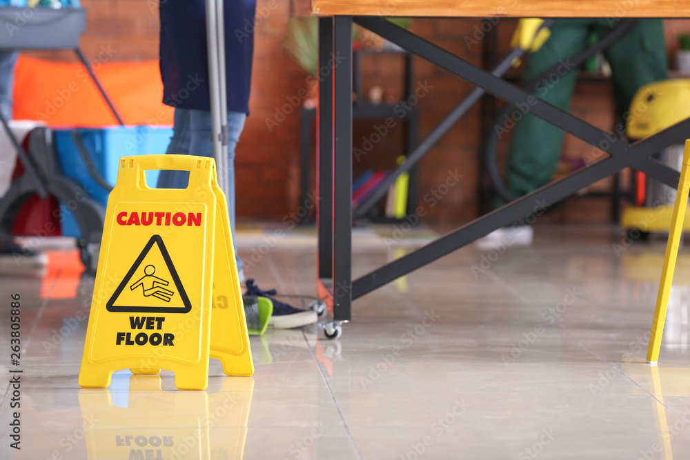 Sign board on floor in office during cleaning