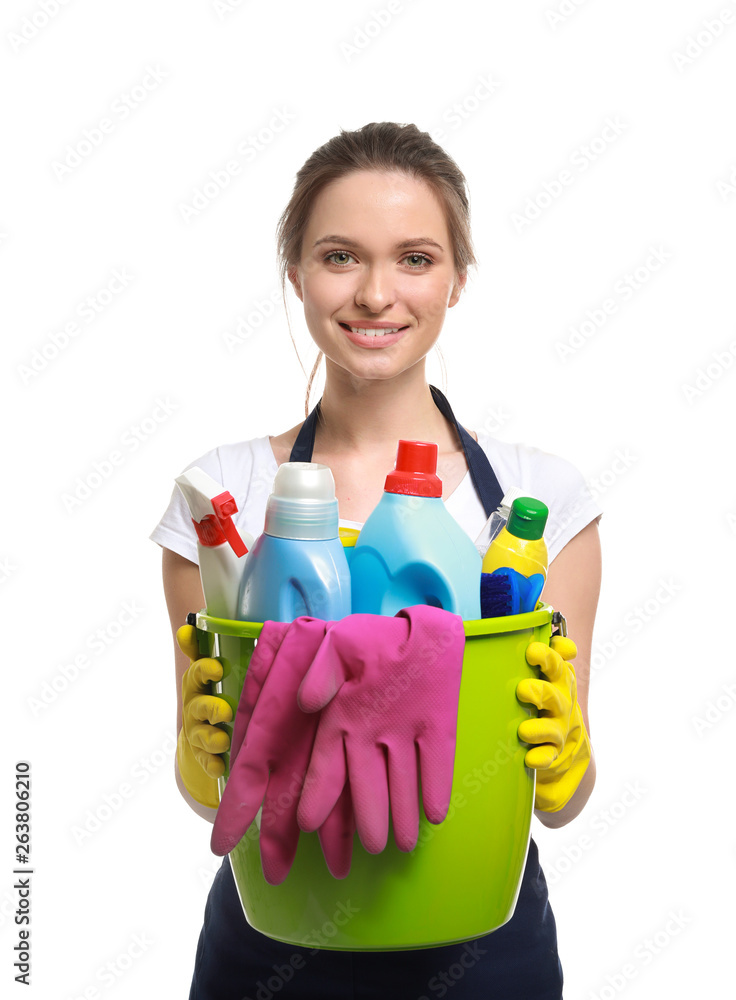 Portrait of female janitor with cleaning supplies on white background