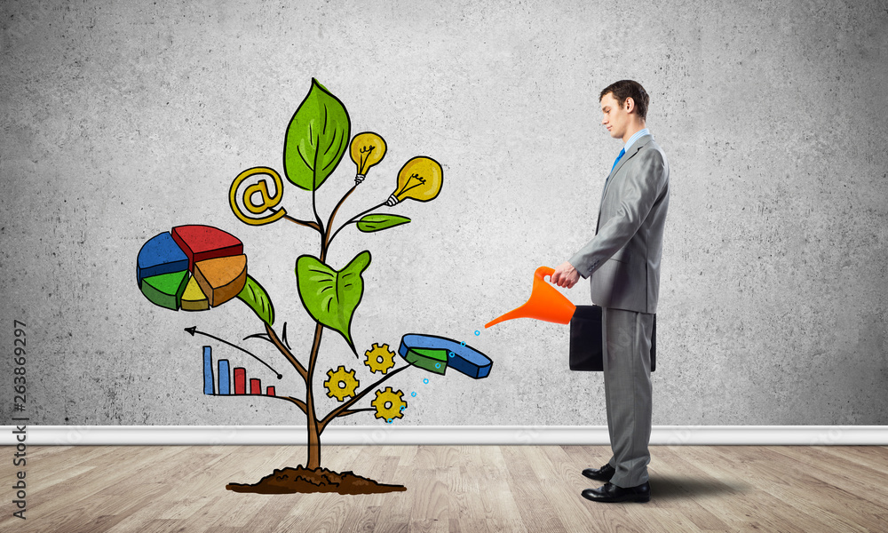 Businessman watering drawing tree with symbols