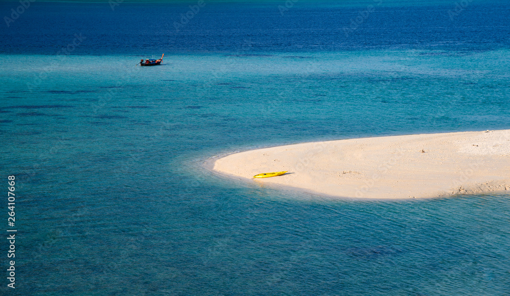 The white beach with yellow canoe in tropical sea