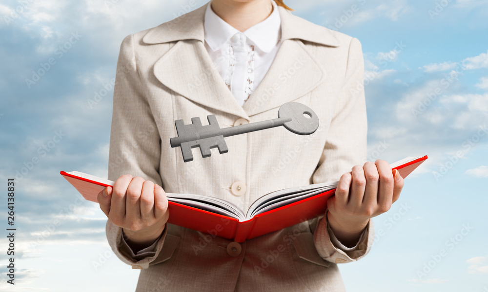 Woman showing big metal key