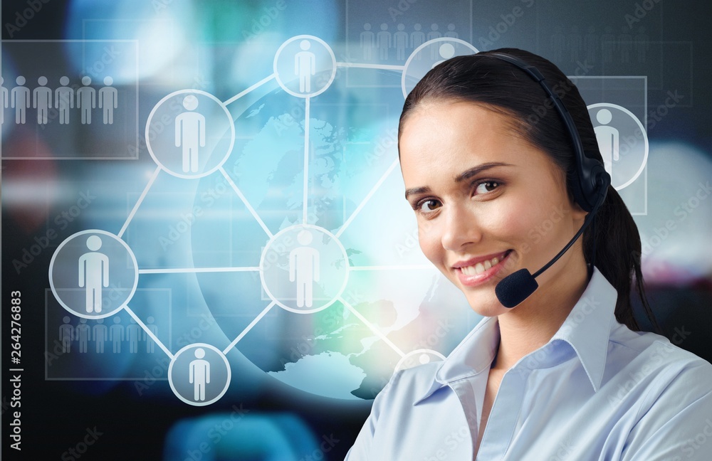 Young female call center worker on blurred technology background