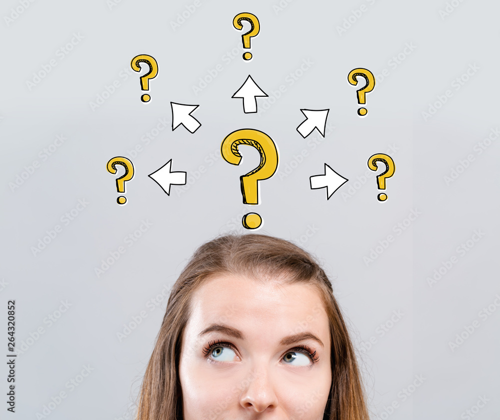 Big and small question marks with arrows with young woman looking upwards