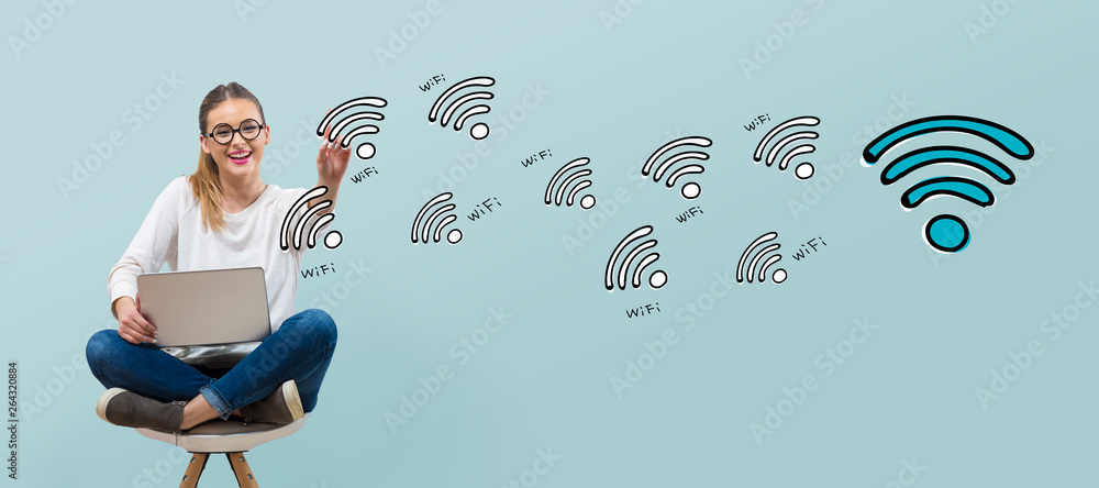 WiFi theme with young woman using her laptop