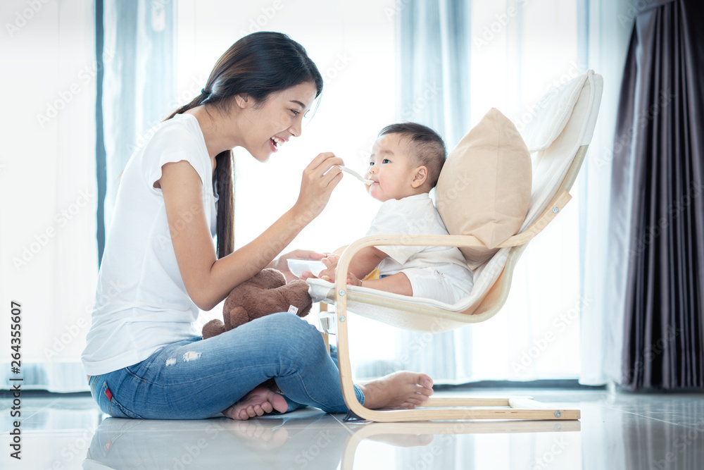 Asian mother feeding to her baby