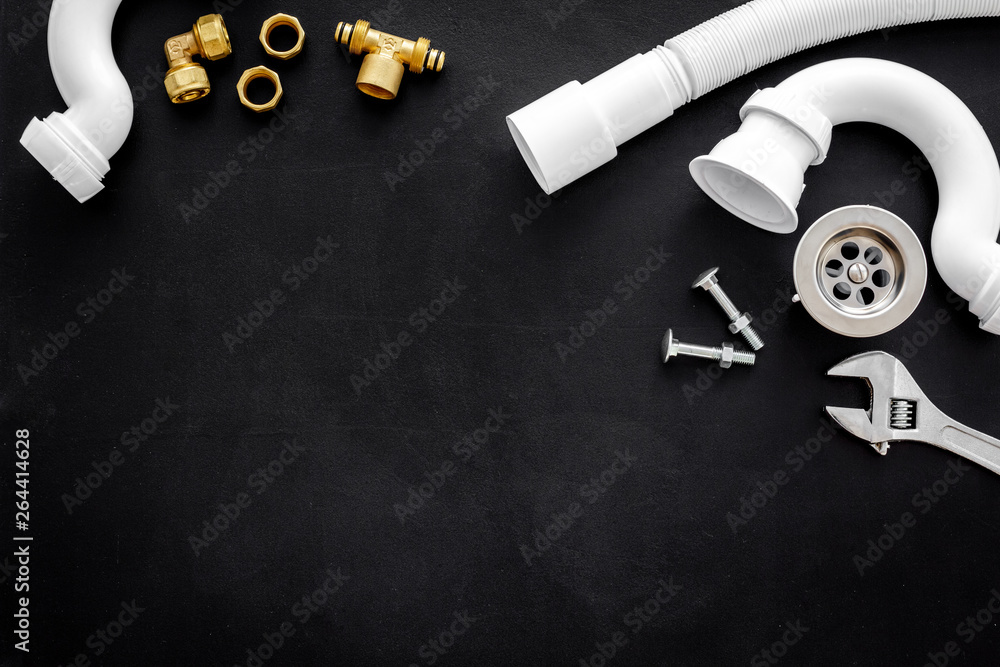 Professional instruments for plumber on black background top view space for text