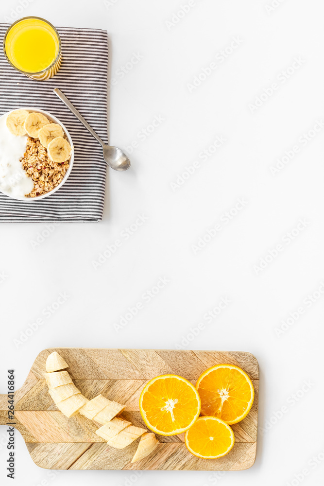 Bright breakfast with granola and orange juice on white background top view mockup