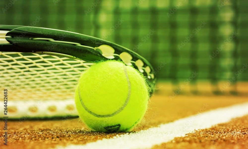 Tennis game. Tennis ball and racket on court background