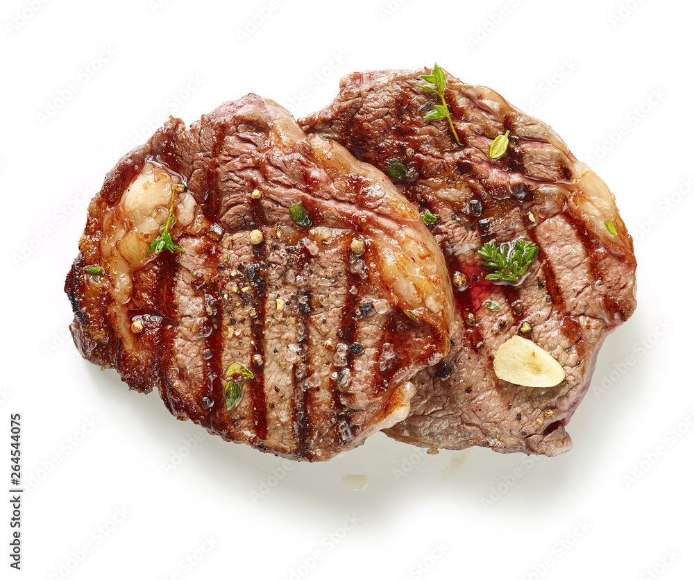 grilled steaks on white background