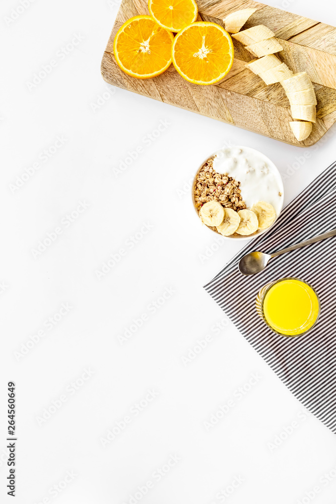 Healthy granola and orange juice for colorful breakfast on white background top view mock-up