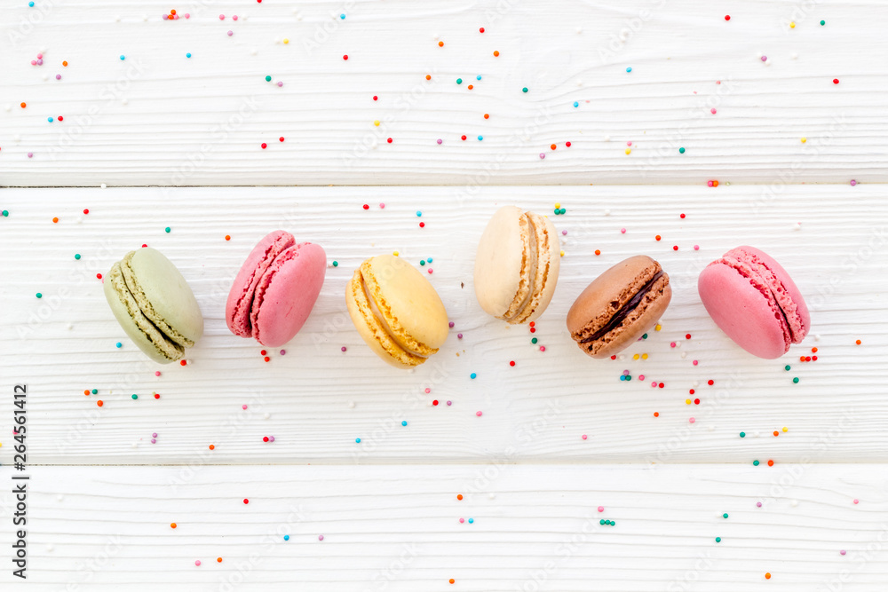 Macarons dessert pattern on white wooden background top view copy space