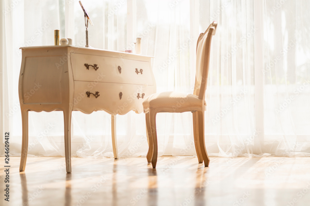 white vintage style wood table and chair with morning light from window