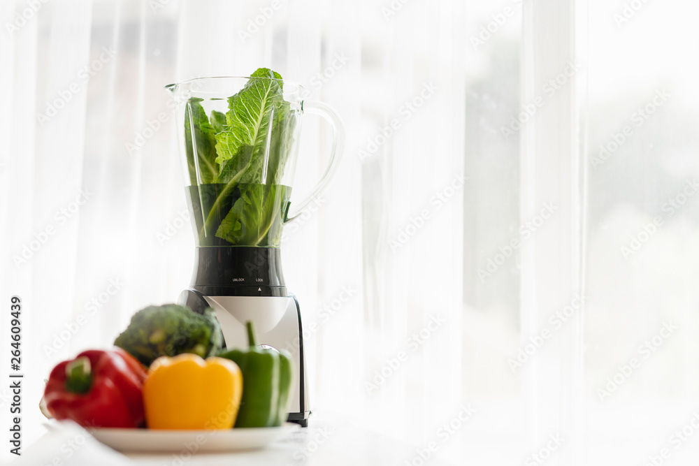 healthy food and good eating with fresh vagetable with blender machine morning light window backgrou