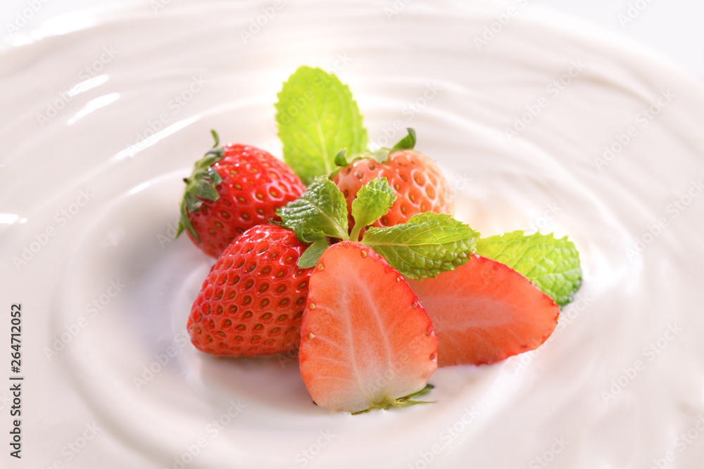 Plain yogurt with fresh strawberries on top isolated on white background