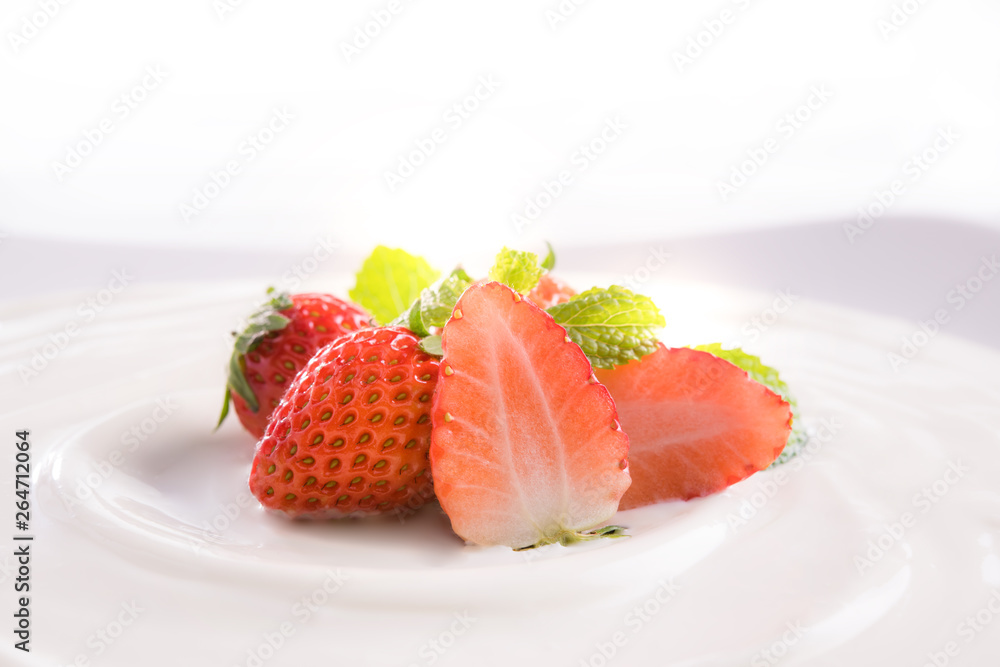 Plain yogurt with fresh strawberries on top isolated on white background