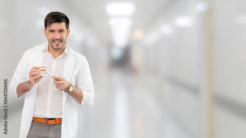 Young male dentist working in dental clinic. Dentistry care and medical service concept.