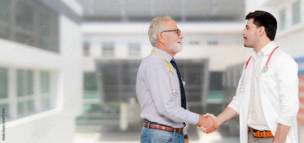 Doctor in hospital handshake with another doctor. Healthcare people teamwork and medical service con