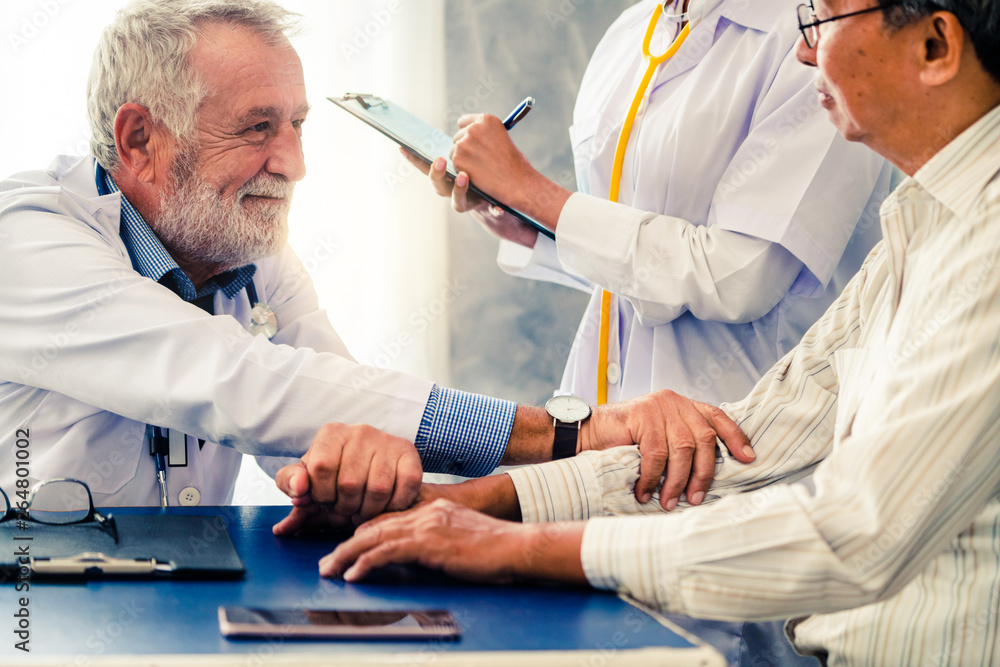 Senior male doctor talking to elder man patient in the hospital office. Medical healthcare and docto