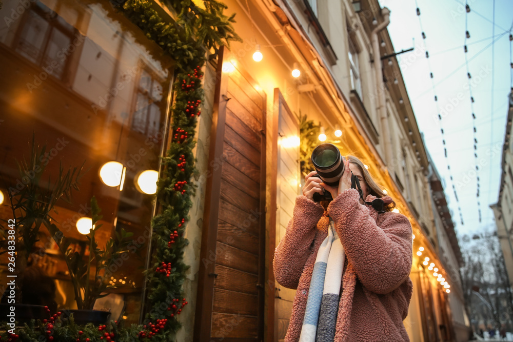 Female photographer outdoors on Christmas eve