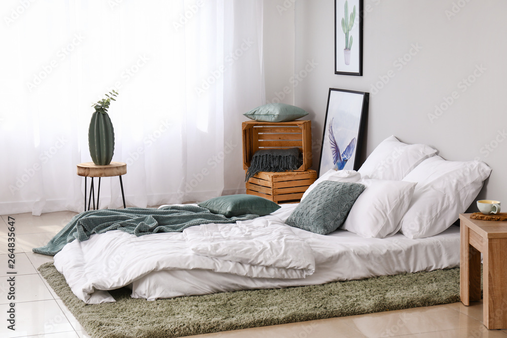 Light curtains and bed in interior of bedroom